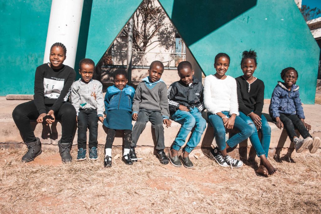 Beneficiaries of Everybody Love Everybody NGO sitting outside SciBono on outing day